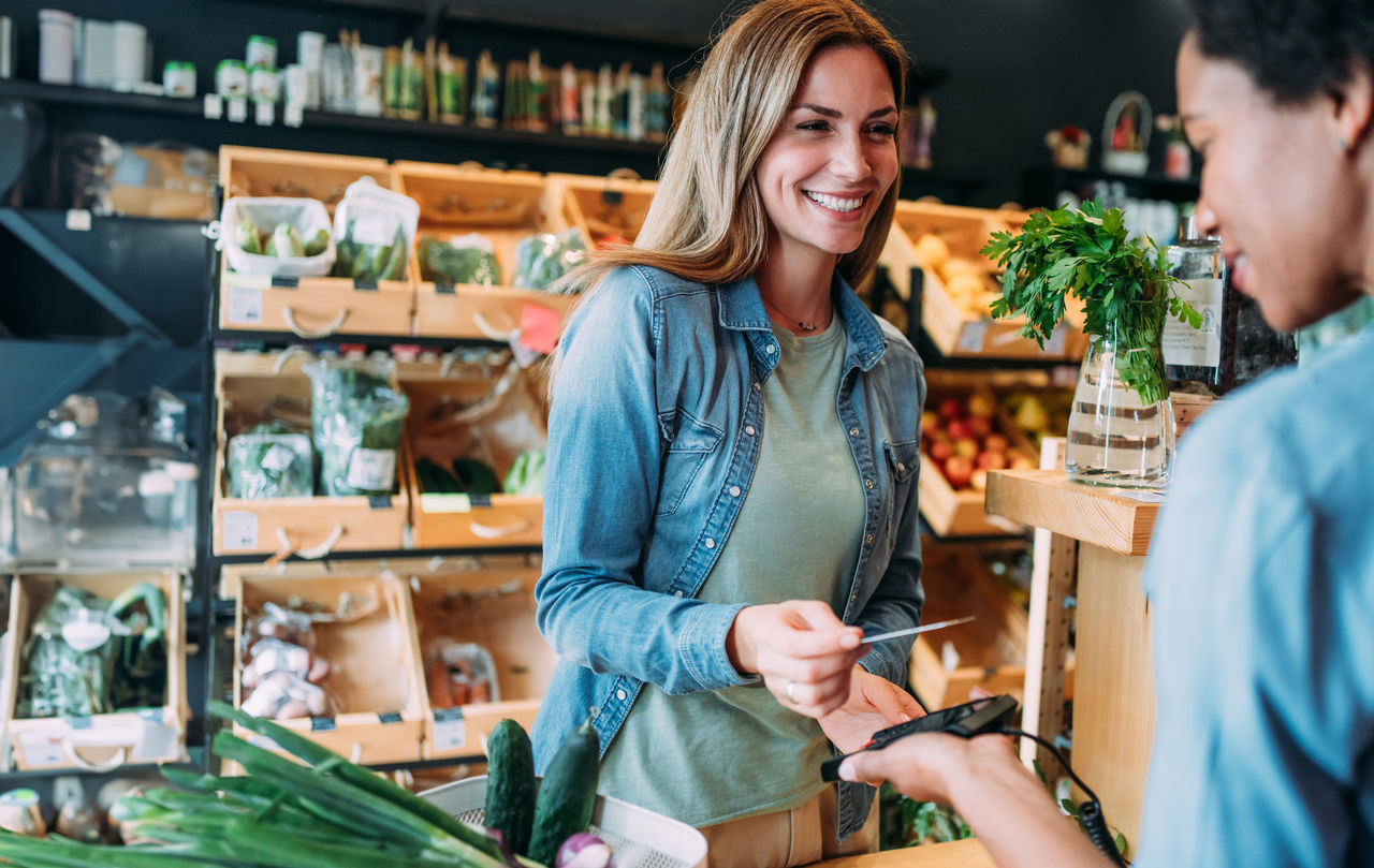 Woman paying for her groceries with her credit card
