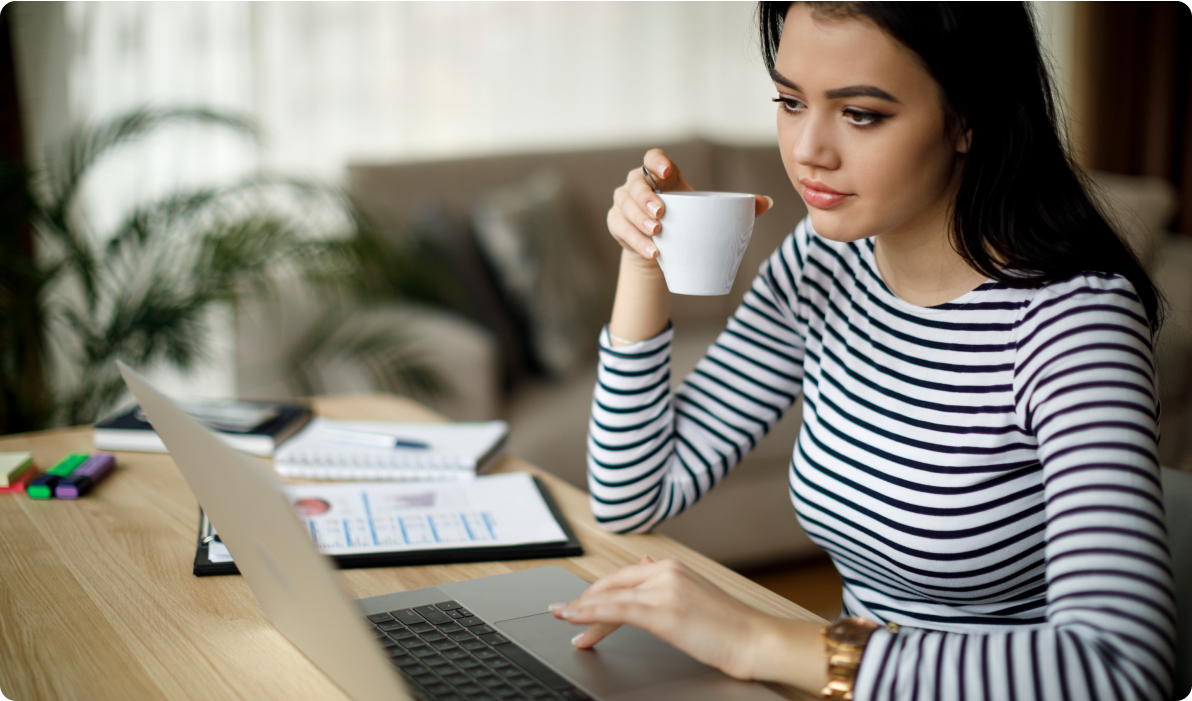Girl on computer with coffee