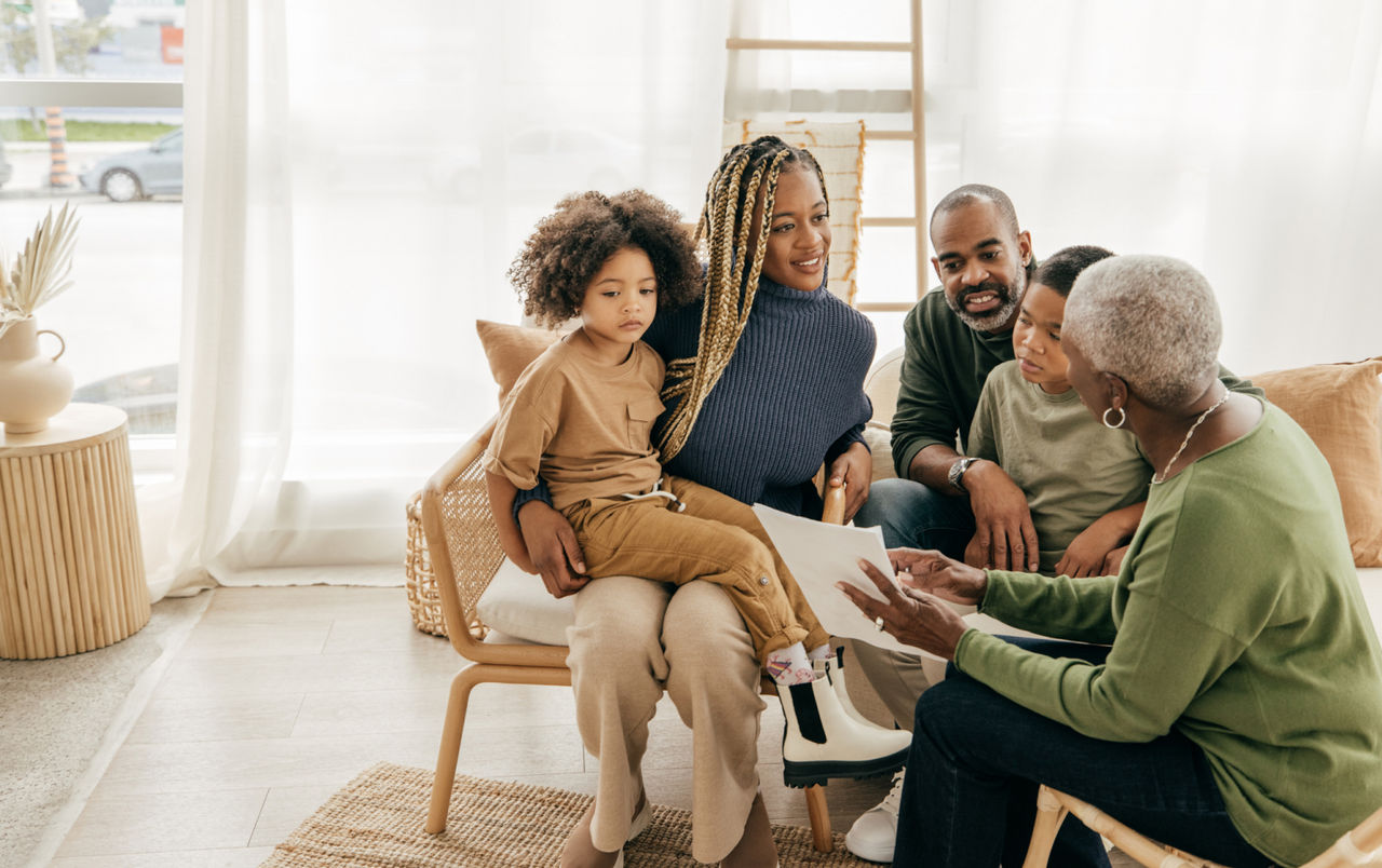 Elderly woman sitting with her family and going over estate planning documents